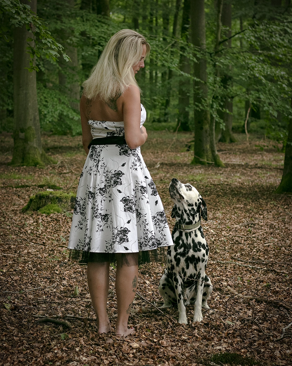 Sinnliches Outdoor Portrait einer Frau mit Rückentattoo und ihrem Dalmatiner im Wald bei Rostock, fotografiert von Tempel Design